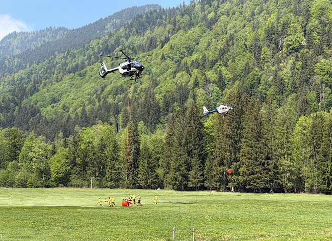 <p>Hubschrauber nehmen Wasser auf, um den Waldbrand am Saurüsselkopf zu bekämpfen. Bild vom 05. Mai 2026.</p>